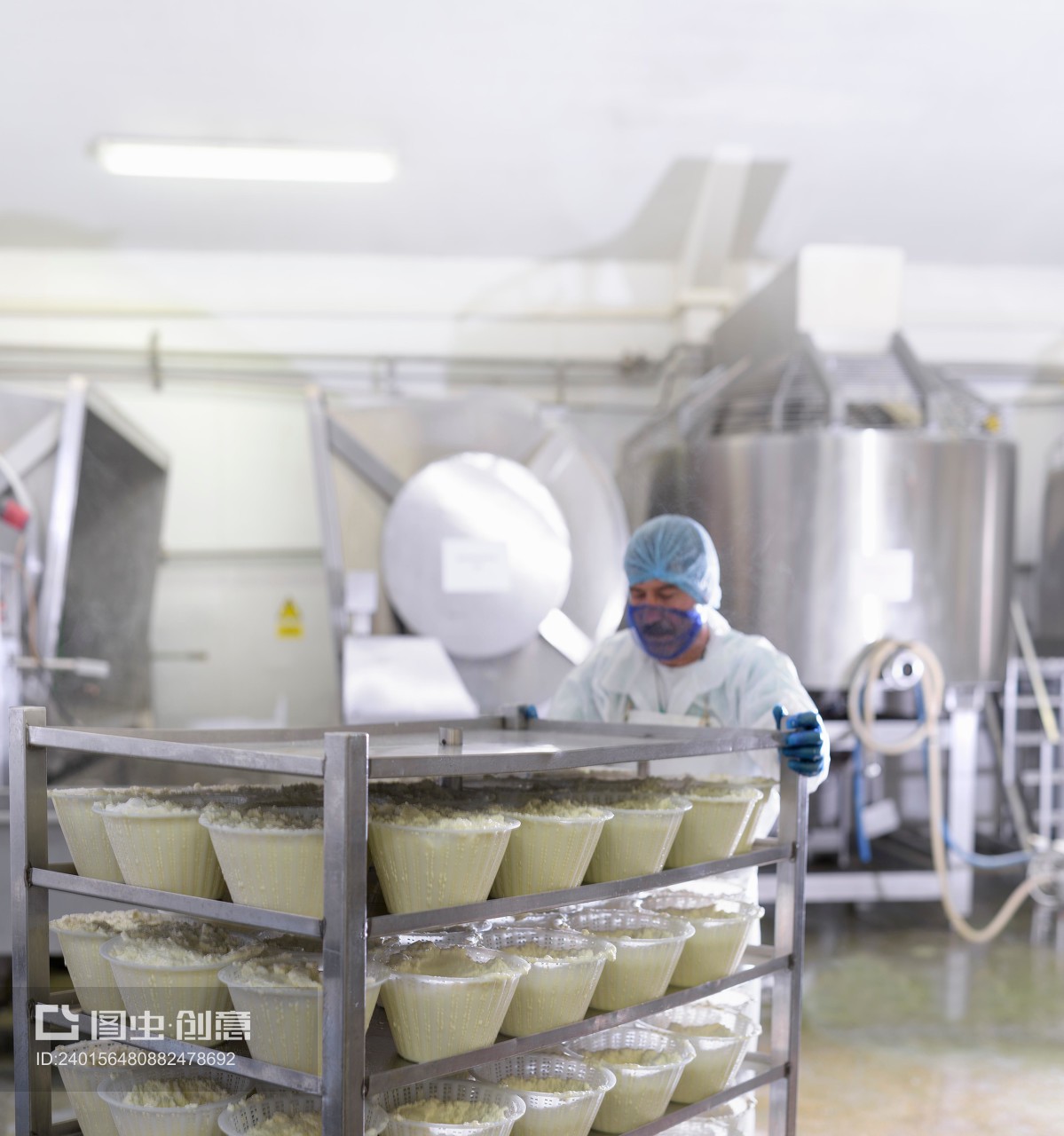 Worker with ricotta cheese in cheese factory